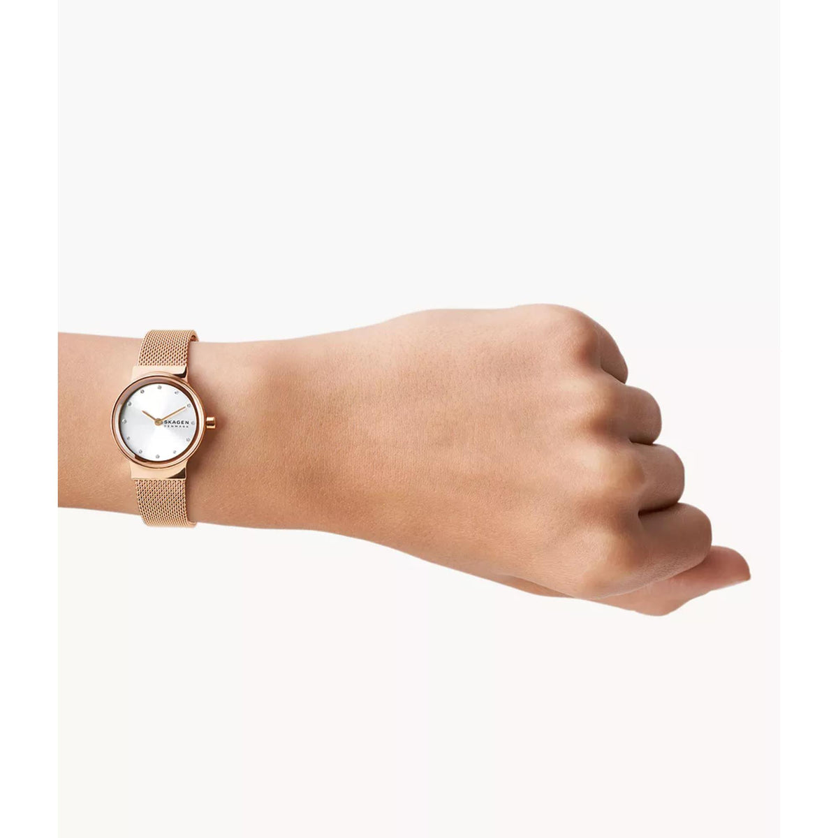 Skagen Freja rose gold wristwatch with white dial on wrist, mesh metal bracelet