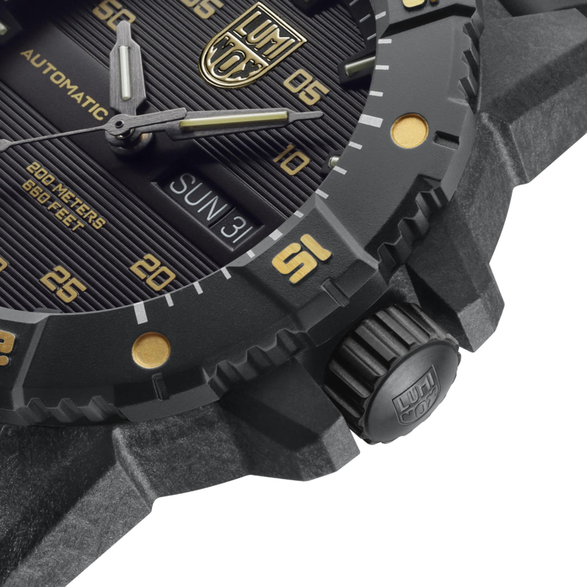 Close-up of watch bezel and crown with textured case and gold-toned hour markers
