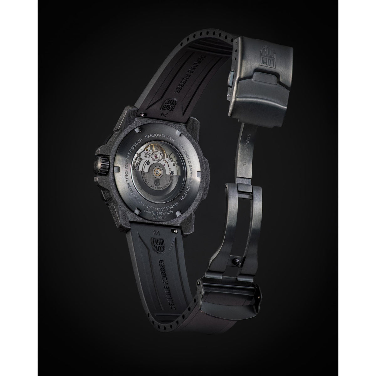 Side view of black dive watch with bracelet strap and visible caseback