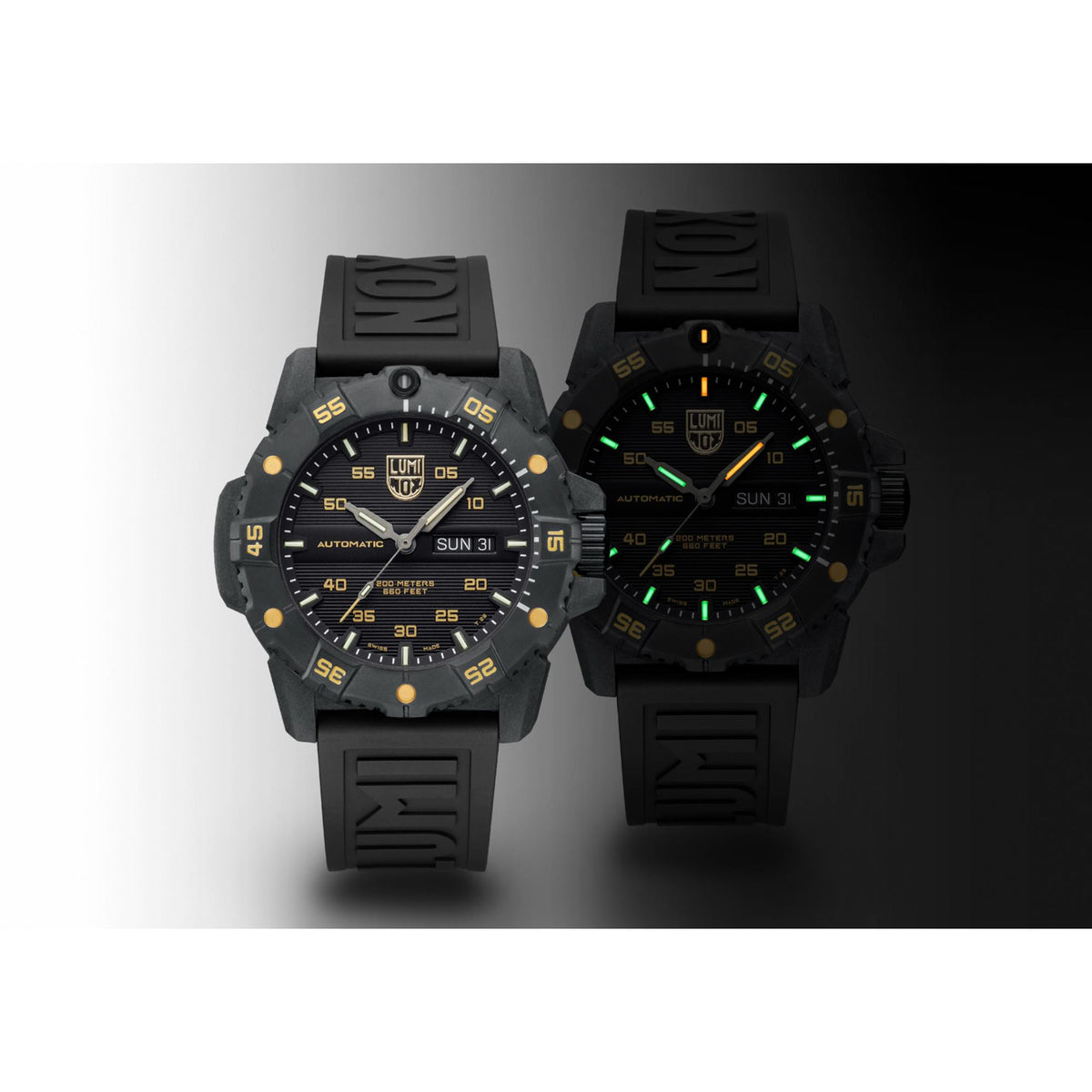 Men’s automatic watch pair with black dials, gold accents, and black rubber straps