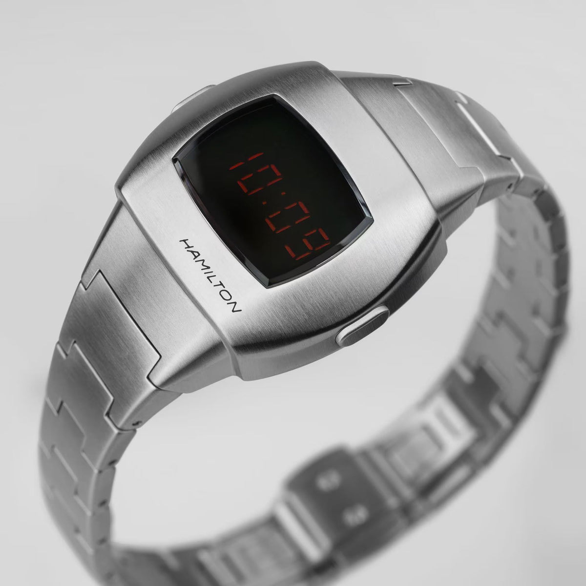 Brushed Hamilton digital watch face with red segmented time on black screen