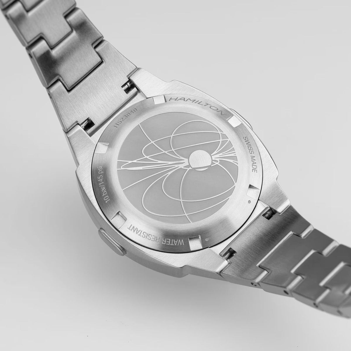 Stainless steel caseback with engraved design on digital Hamilton watch
