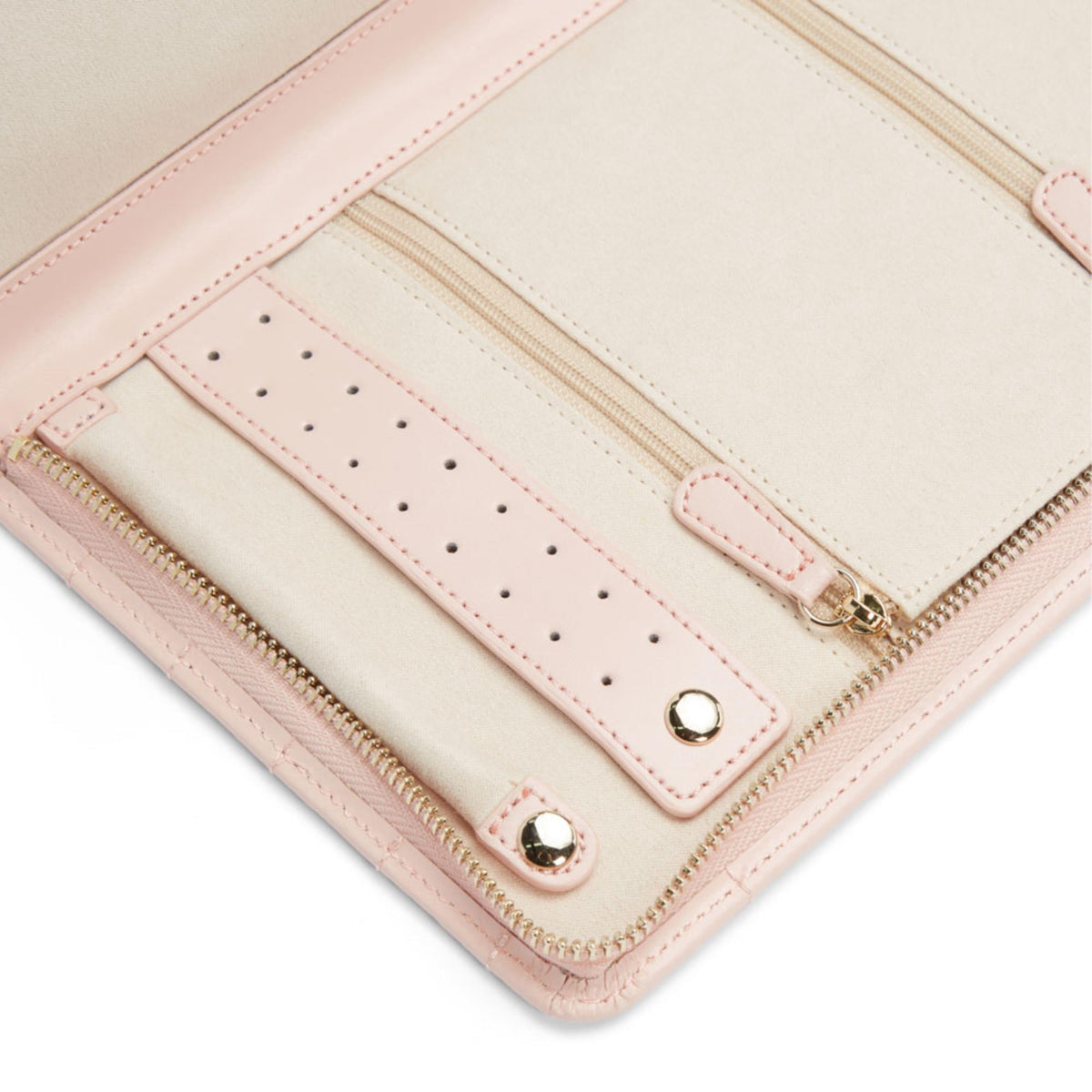 Close-up of pale pink interior earring slots with gold hardware and zipper