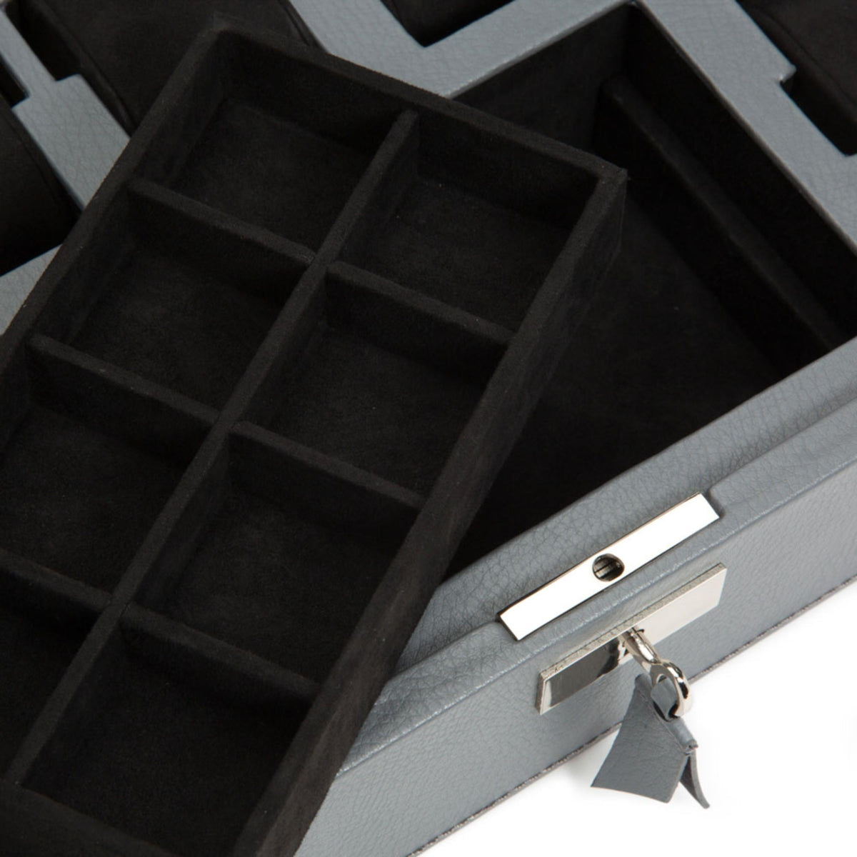 Wolf Howard watch box interior close-up with black grid compartments and gray locking hardware