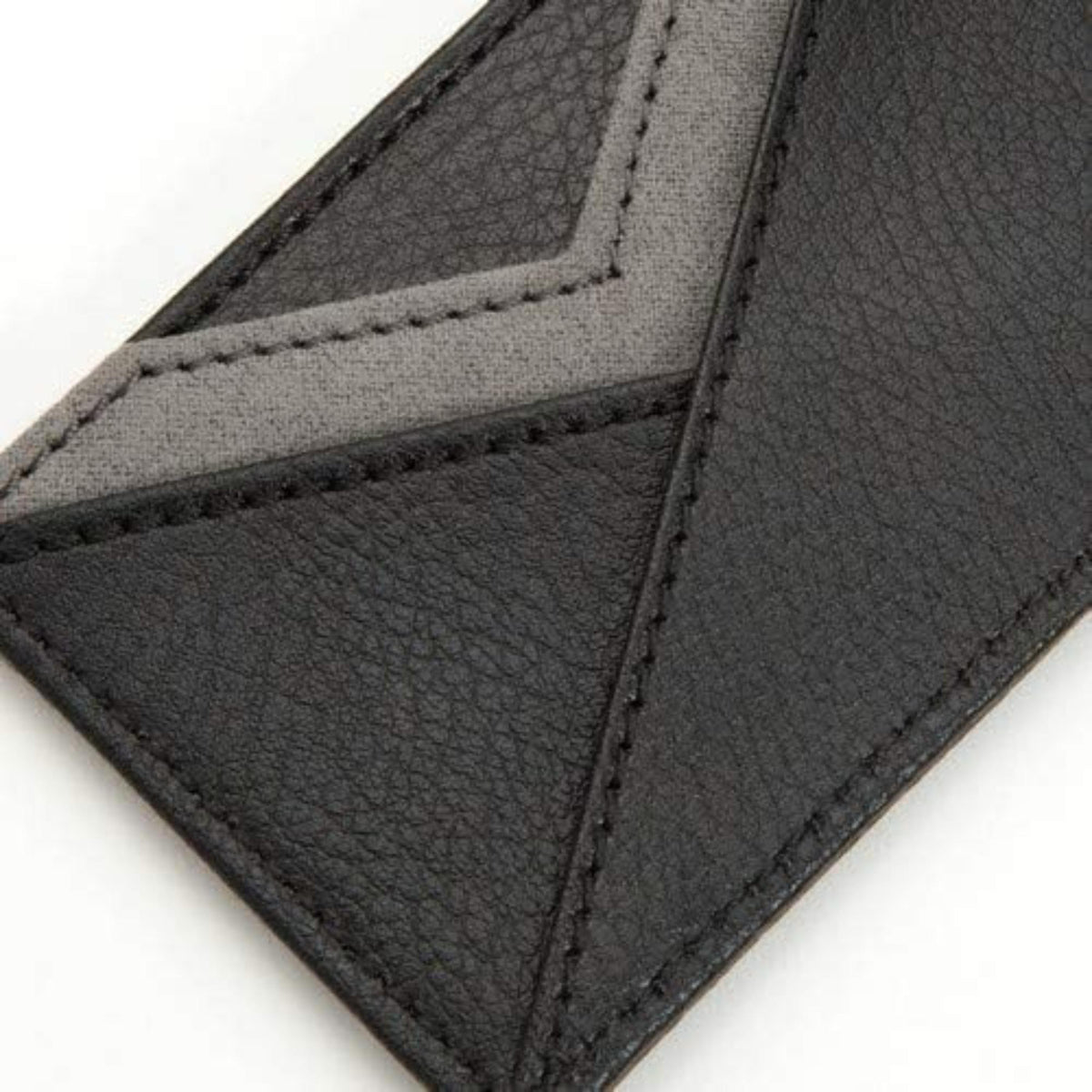 Close-up of black leather card wallet interior with gray panels and stitched seams