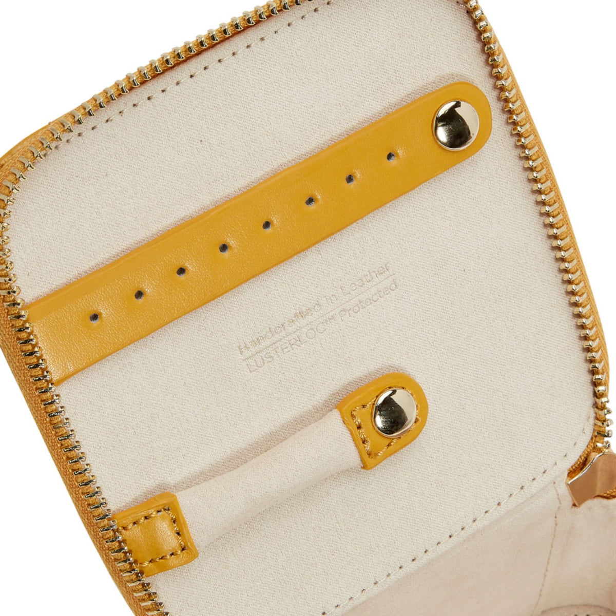 Beige-lined interior jewelry cube panel with yellow leather straps and silver snap hardware