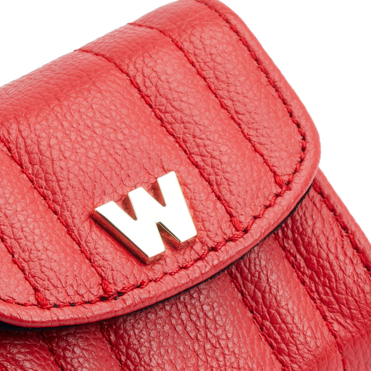 Close-up of red EarPods case flap with gold W emblem and textured leather