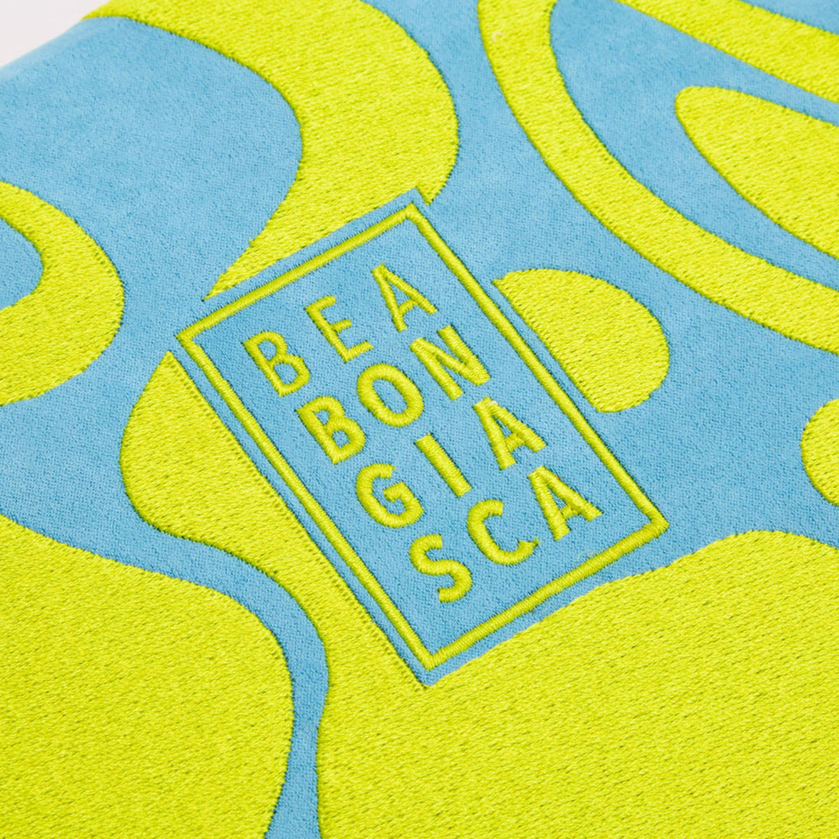 BEA BON GIA SCA logo badge centered on blue and lime abstract tray design