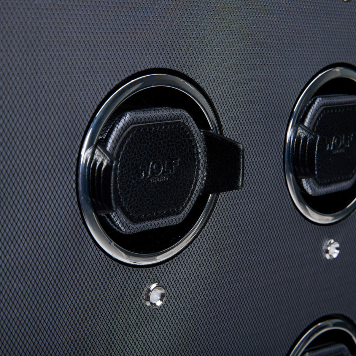 Close-up of black watch holder cover with WOLF logo and chrome ring details