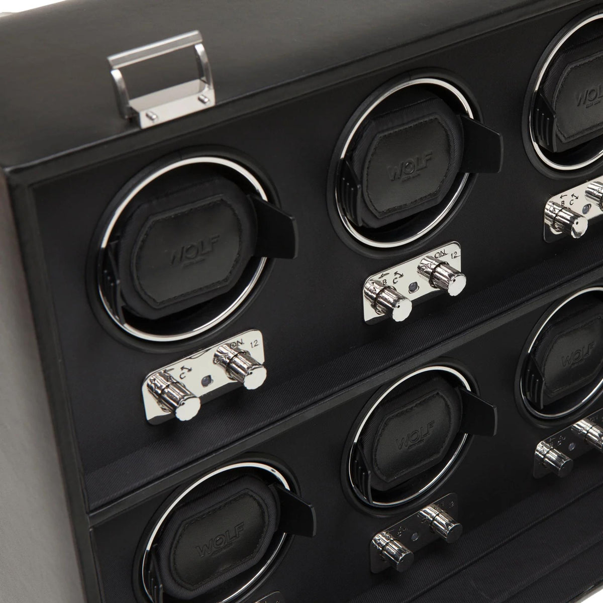 Close-up of black 8-watch winder with four round cradles and chrome control switches