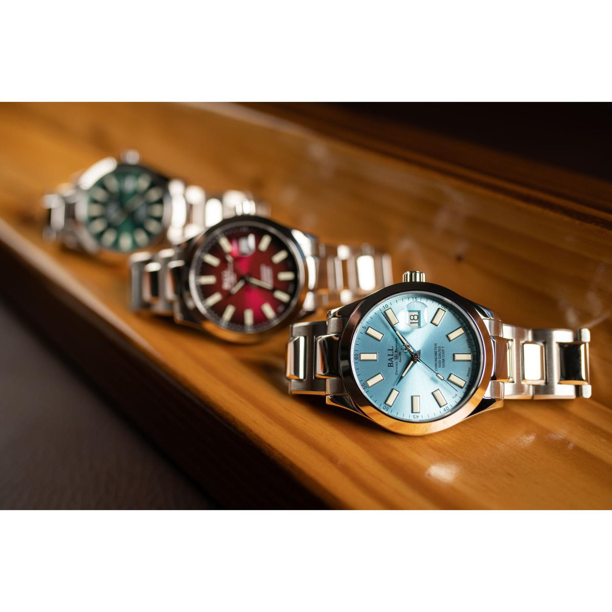 Light blue dial sport watch with metal bracelet, among other watches