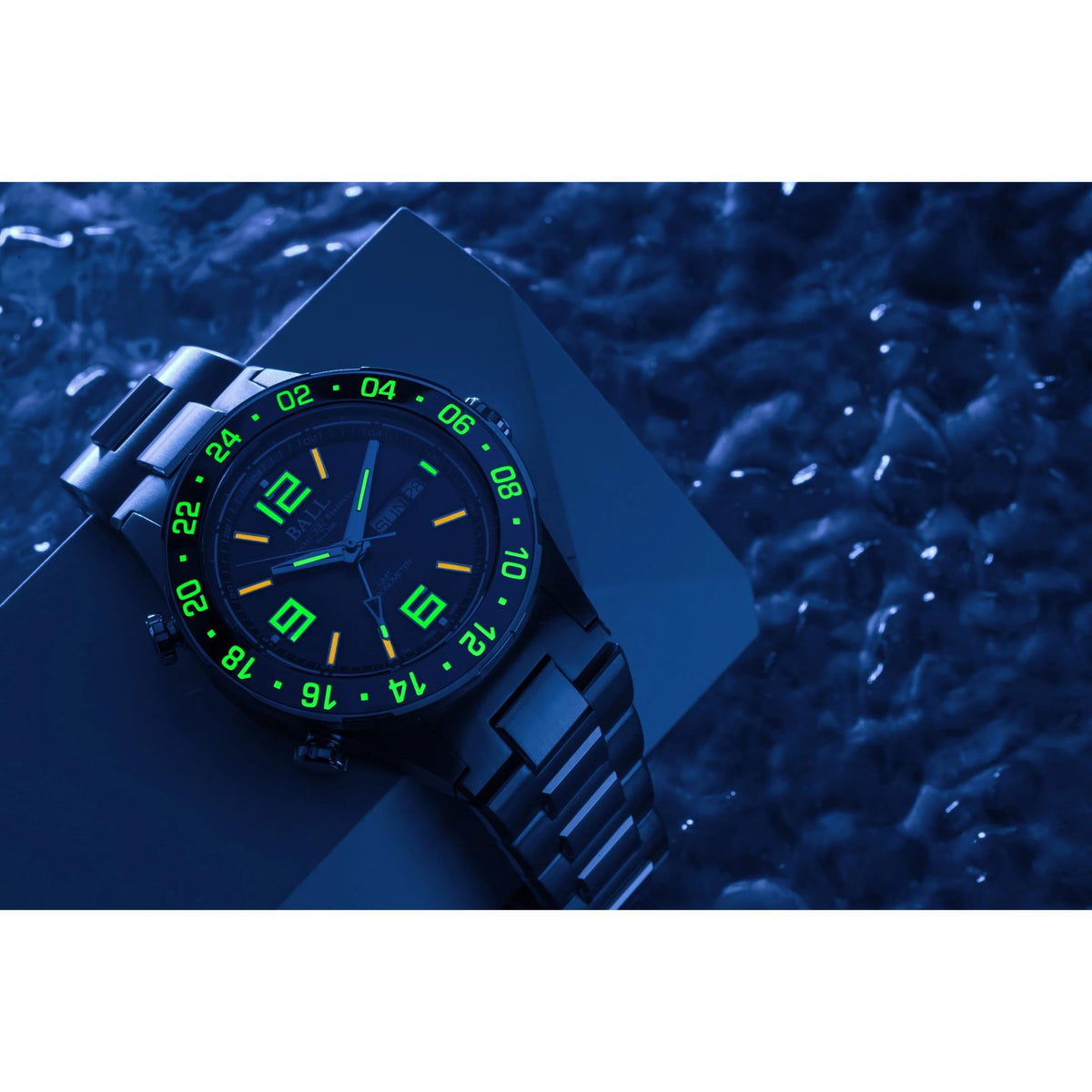 Men's blue dial watch with green luminous markers and black link bracelet