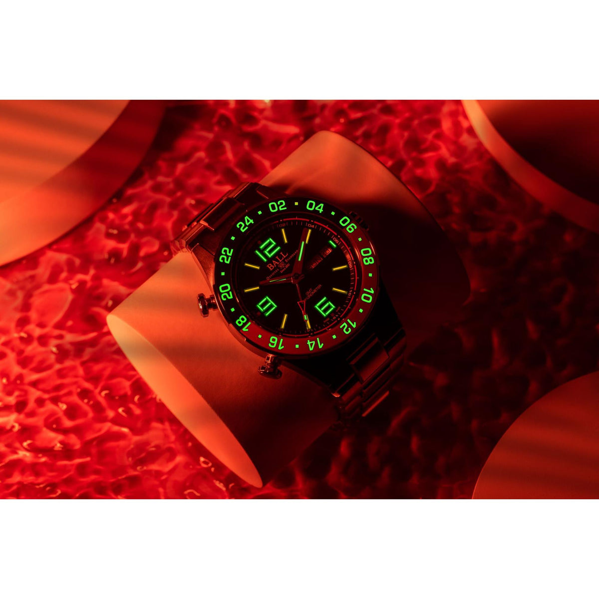 Men's black steel diver wristwatch with green luminous dial and blue/red bezel
