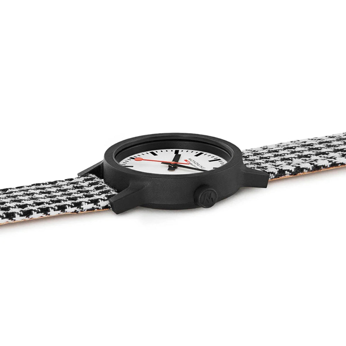 Quartz wristwatch lying on black-and-white houndstooth strap, round black case visible