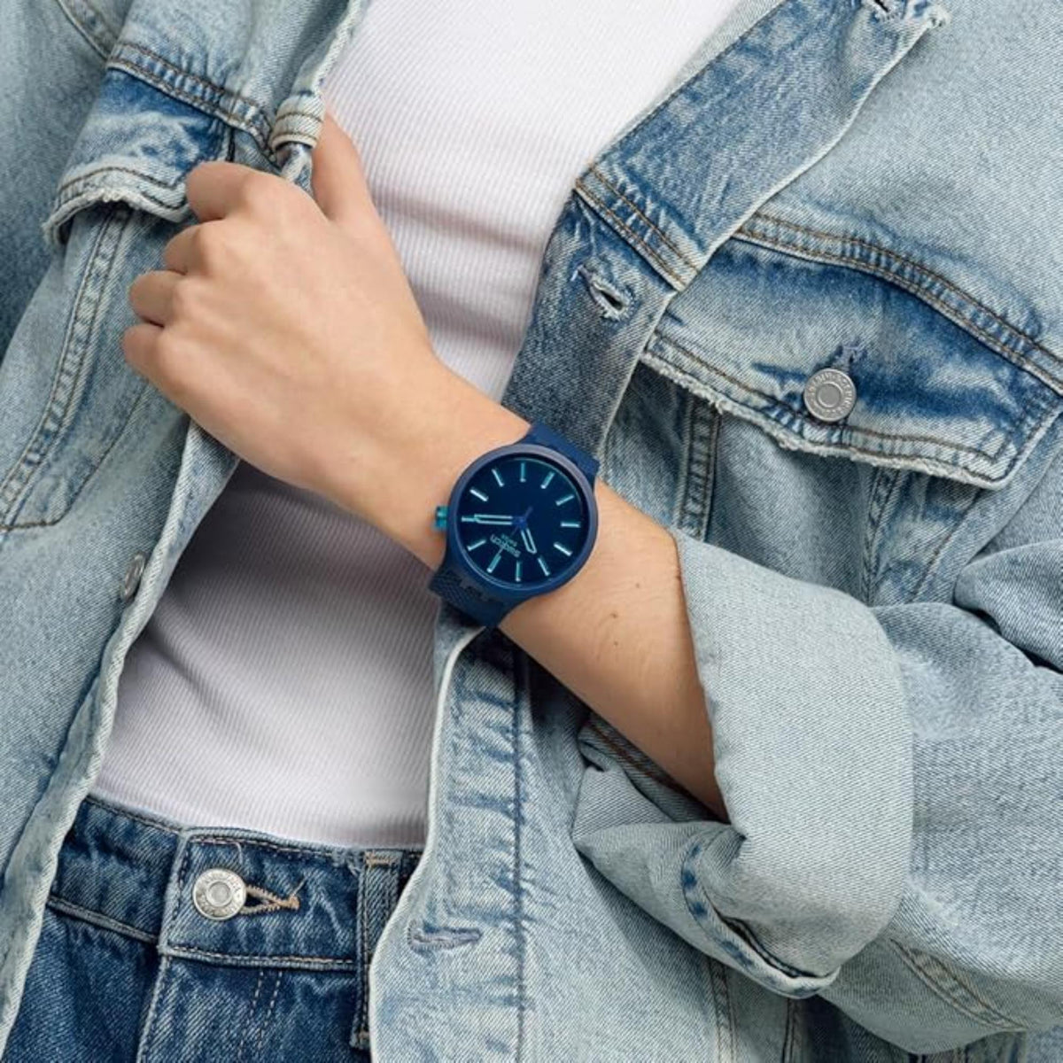 Indigo blue silicone strap watch on wrist, blue dial with glowing index markers