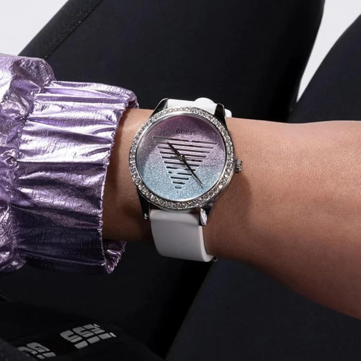 Guess glitter watch on wrist with white silicone band and rhinestone bezel