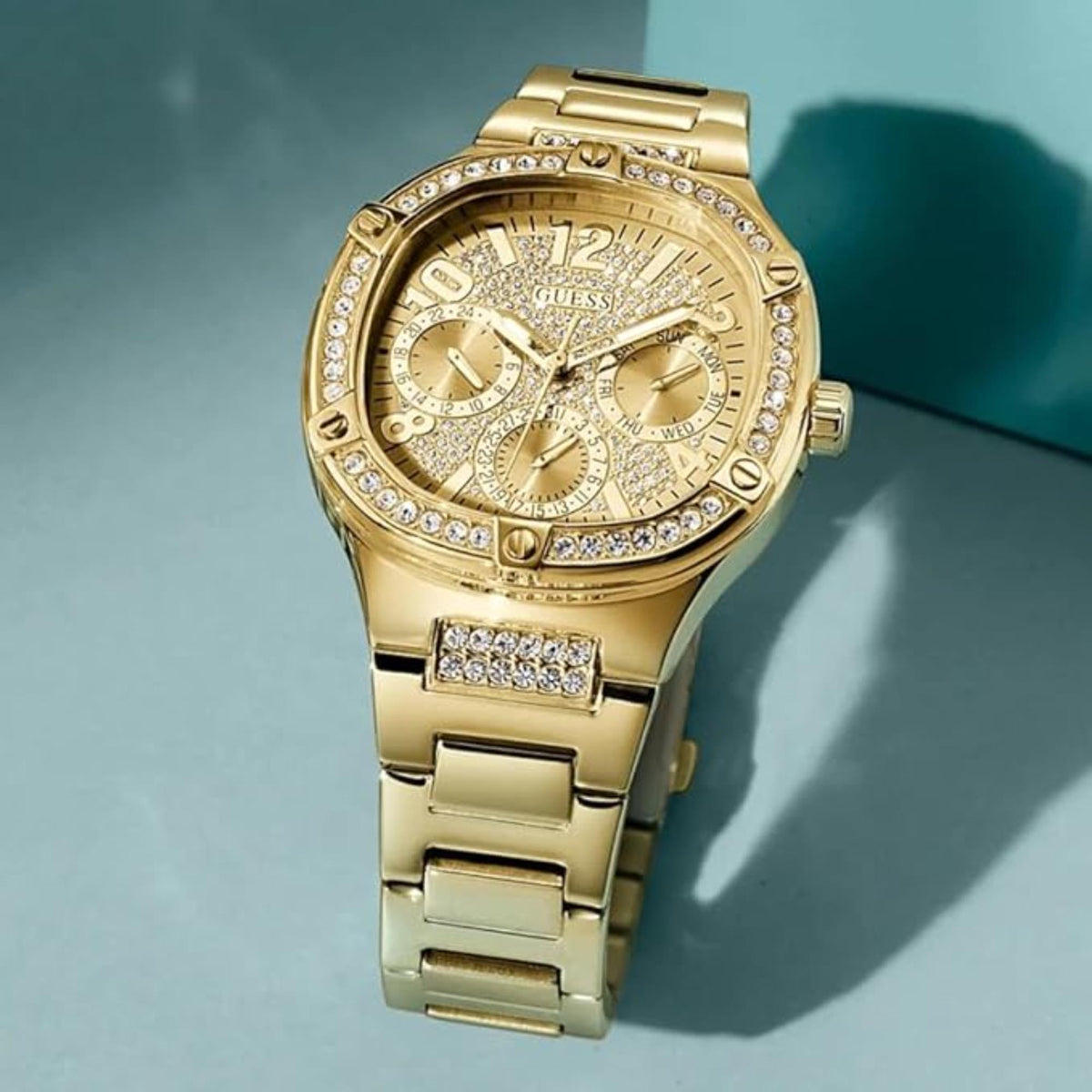 Gold-tone crystal dial bracelet watch with sparkling bezel and three subdials on gold face