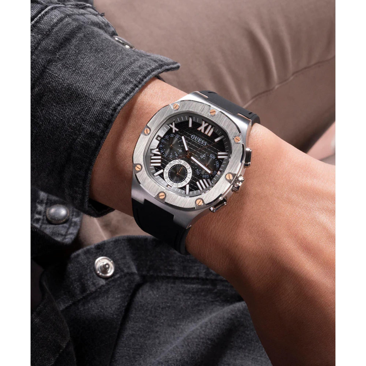 Men's textured dial watch on wrist close-up, black silicone strap and silver bezel