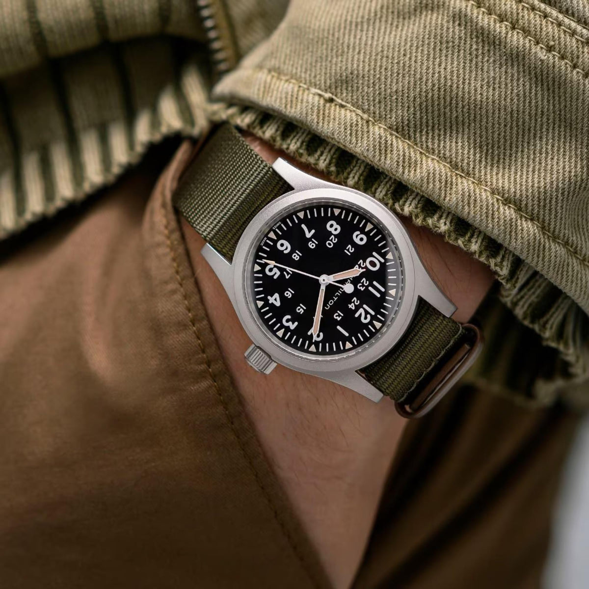 Hamilton watch with khaki green NATO textile strap and round black dial