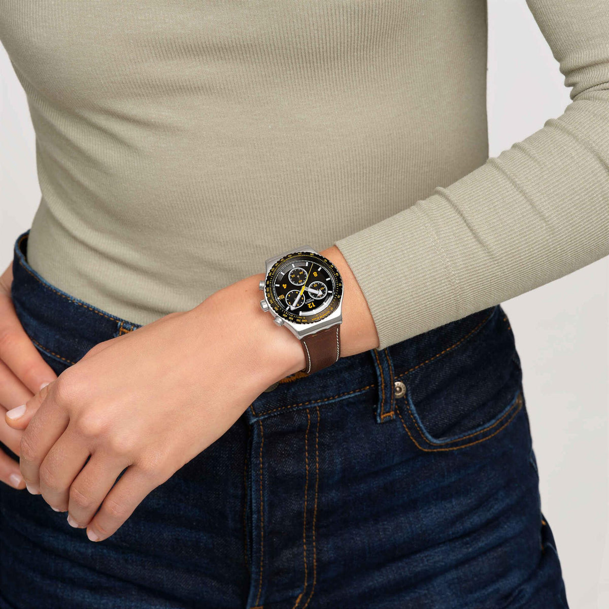 Leather strap chronograph watch on wrist, black dial with yellow bezel and subdials