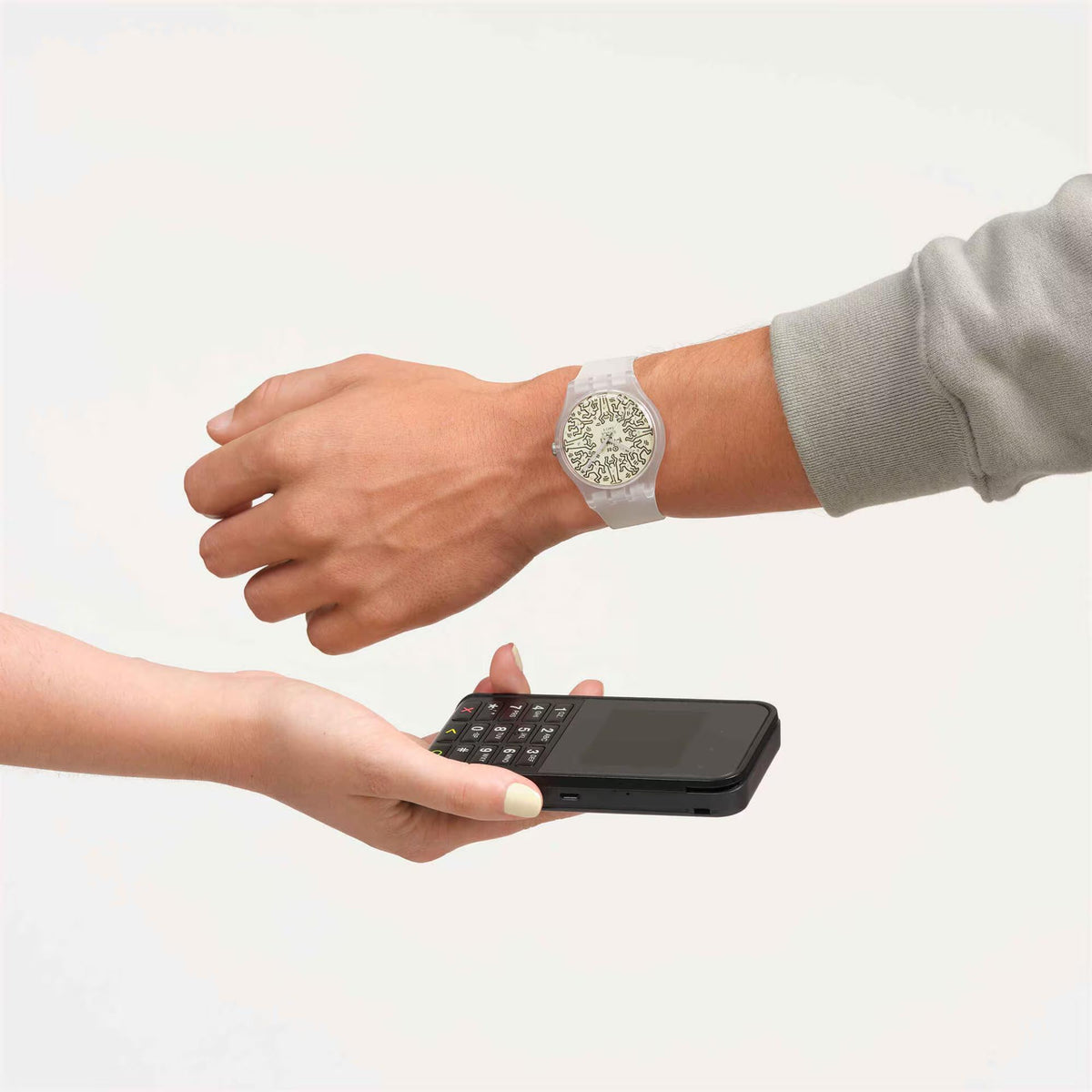 Swatch watch on wrist with patterned beige dial and white silicone strap