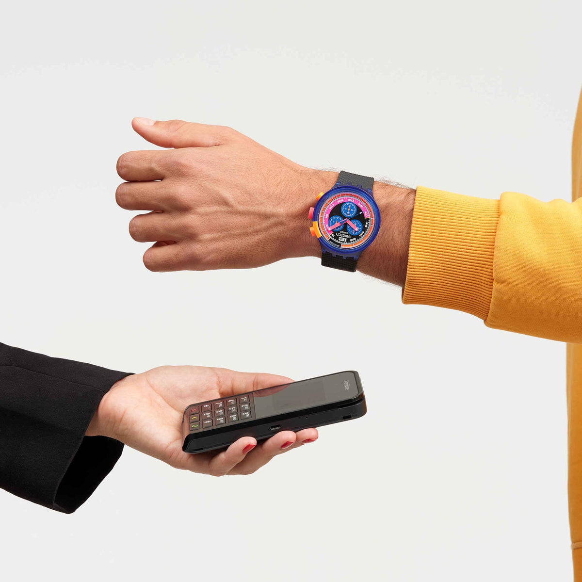 Wristwatch on wrist with bright blue case and orange crown, black dial with multicolor subdials
