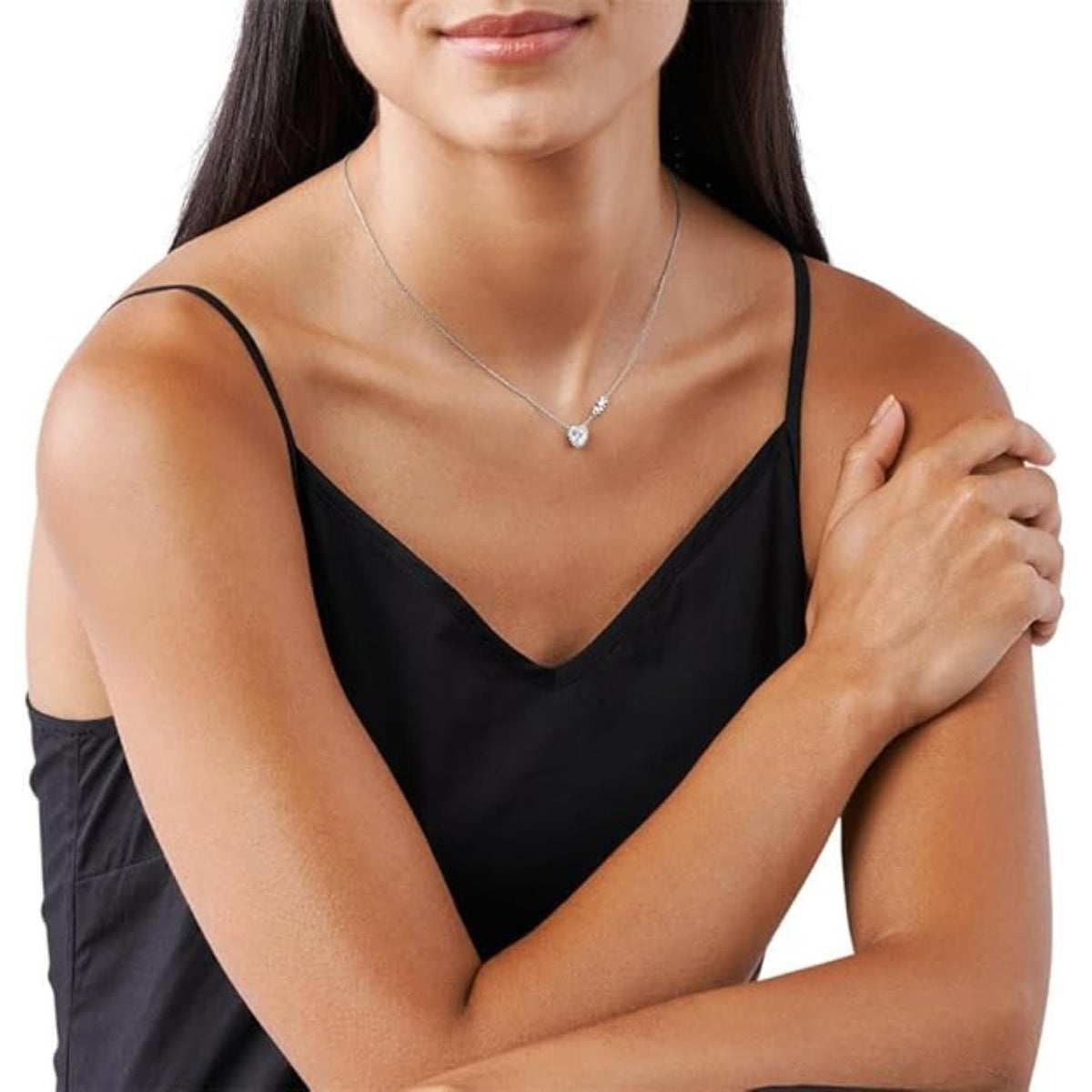 Sterling silver heart pendant necklace worn on model with fine adjustable chain