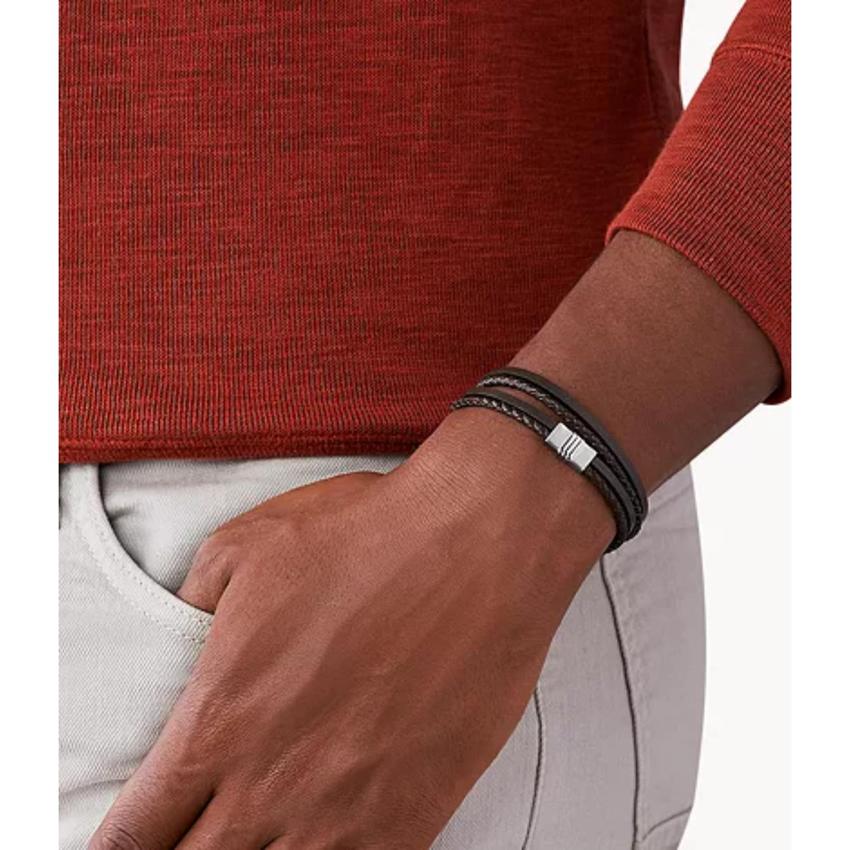 Men's dark-brown braided leather bracelet on wrist with silver bar clasp