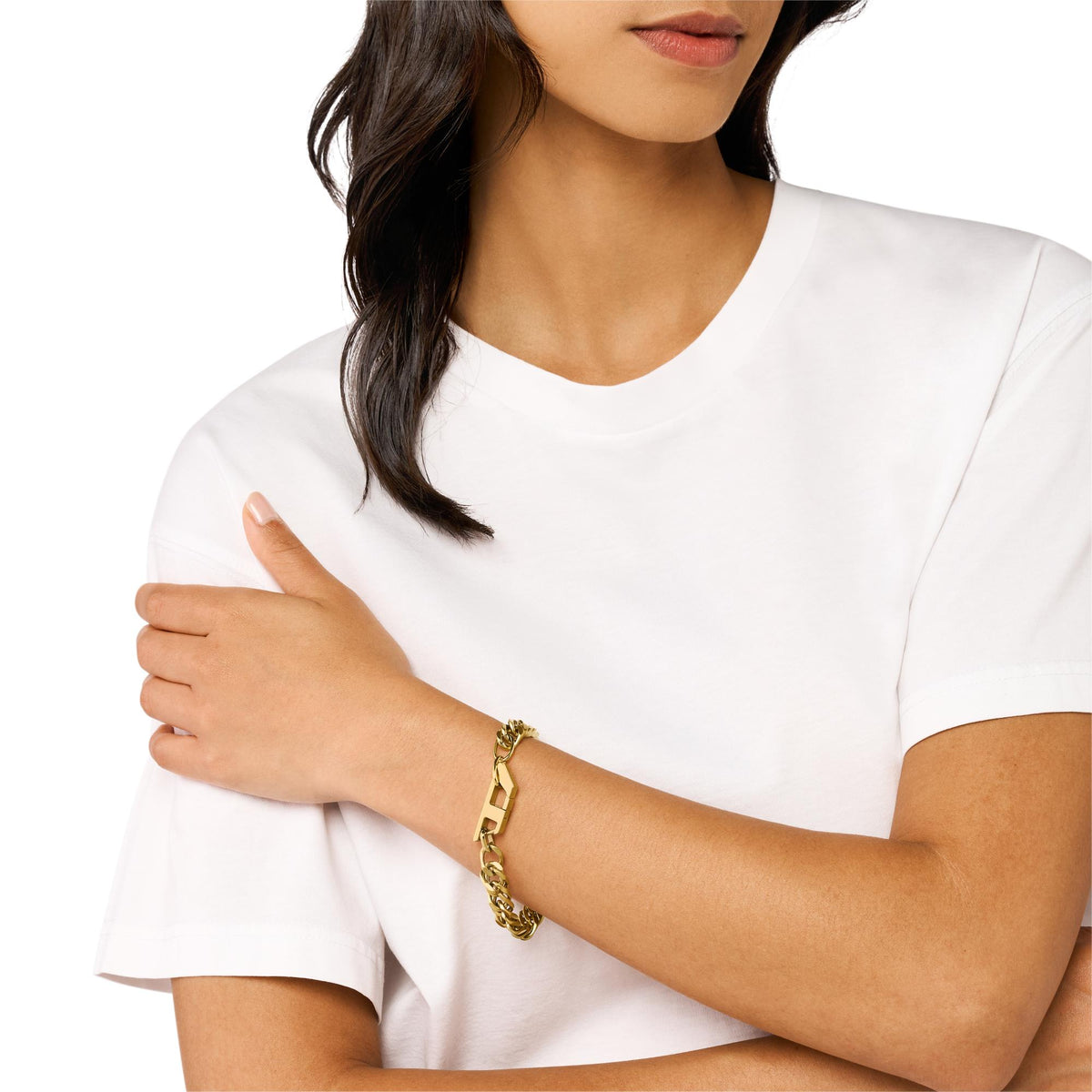Gold-tone chain link bracelet with clasp, worn on forearm