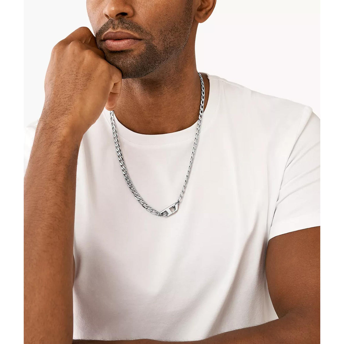 Stainless steel chain necklace on a man’s neckline over a white T-shirt