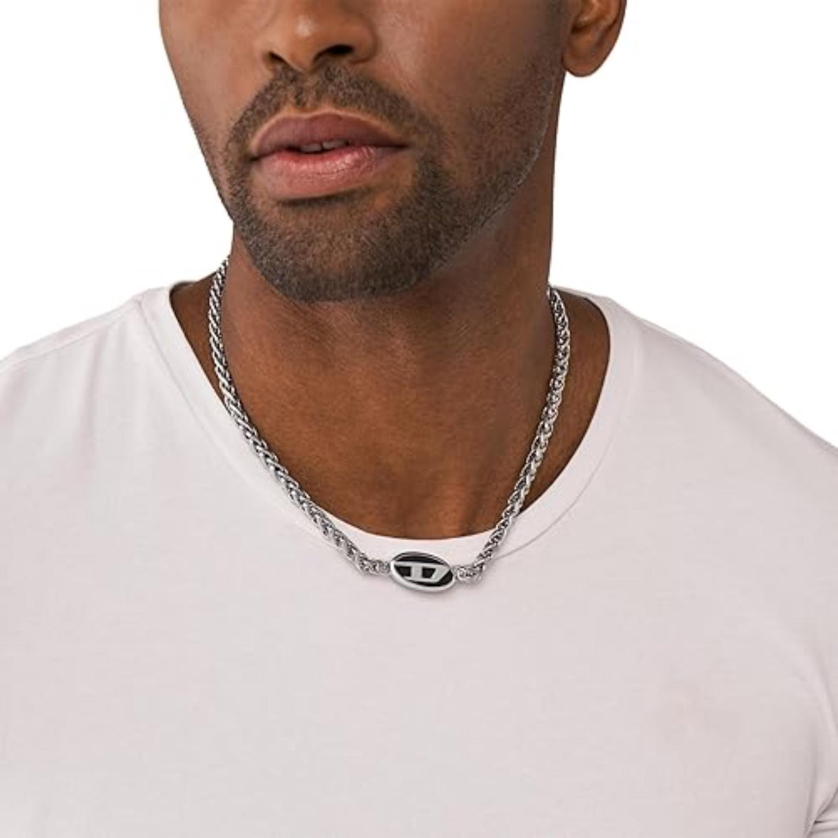 Stainless steel chain necklace with oval logo pendant worn on a man