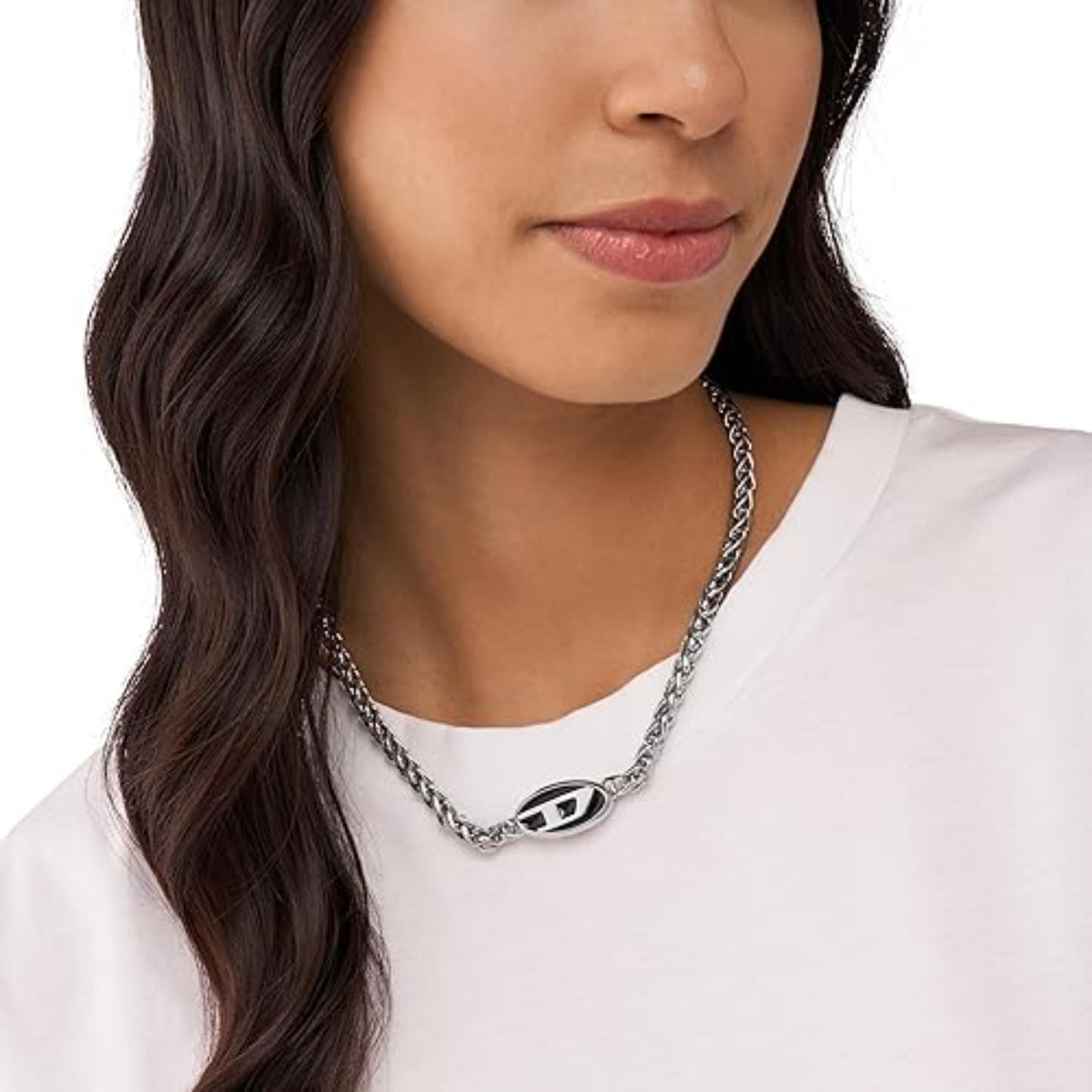 Stainless steel chain necklace with oval logo pendant worn on a woman