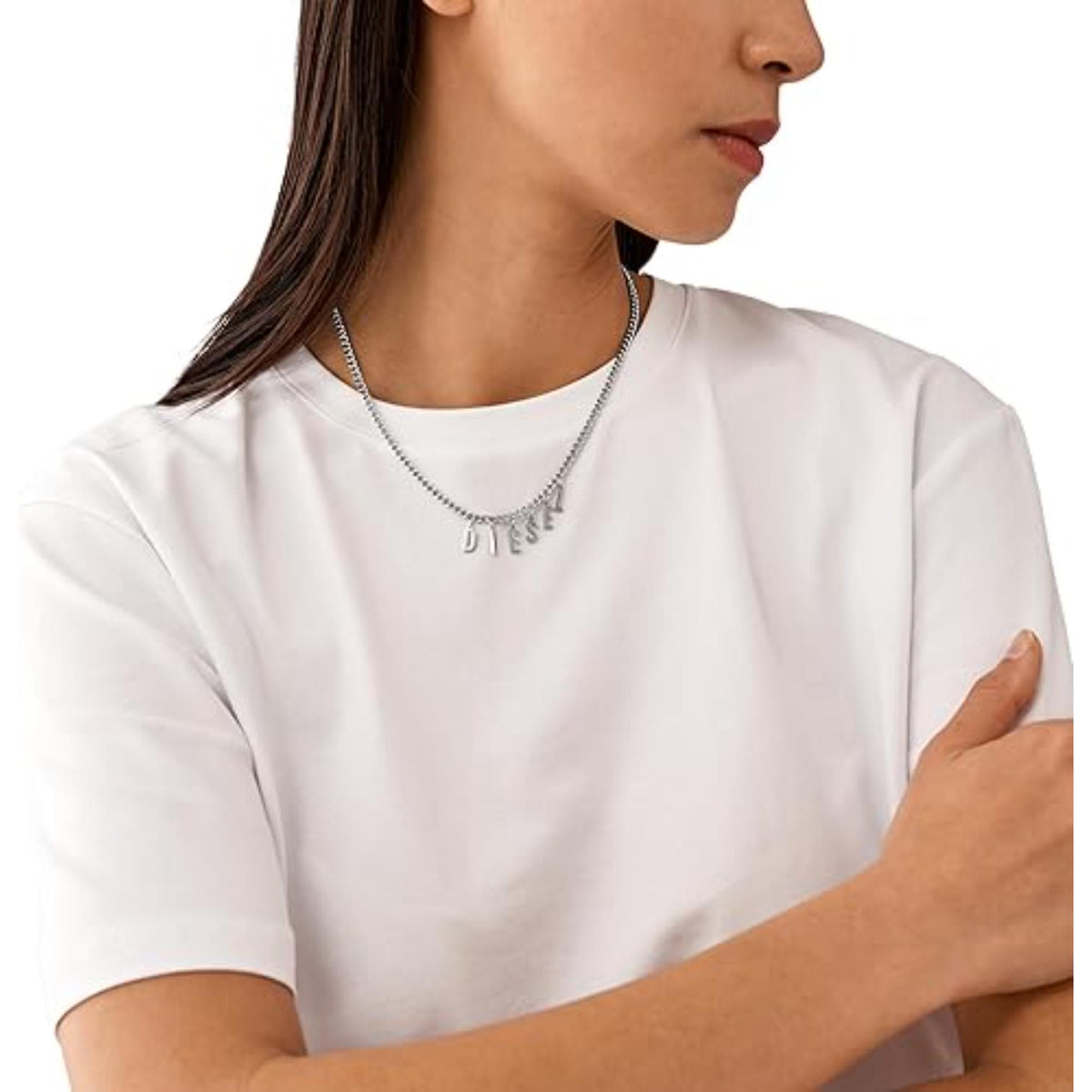 Stainless steel chain necklace with letter charms D I E S E L on a woman’s neck