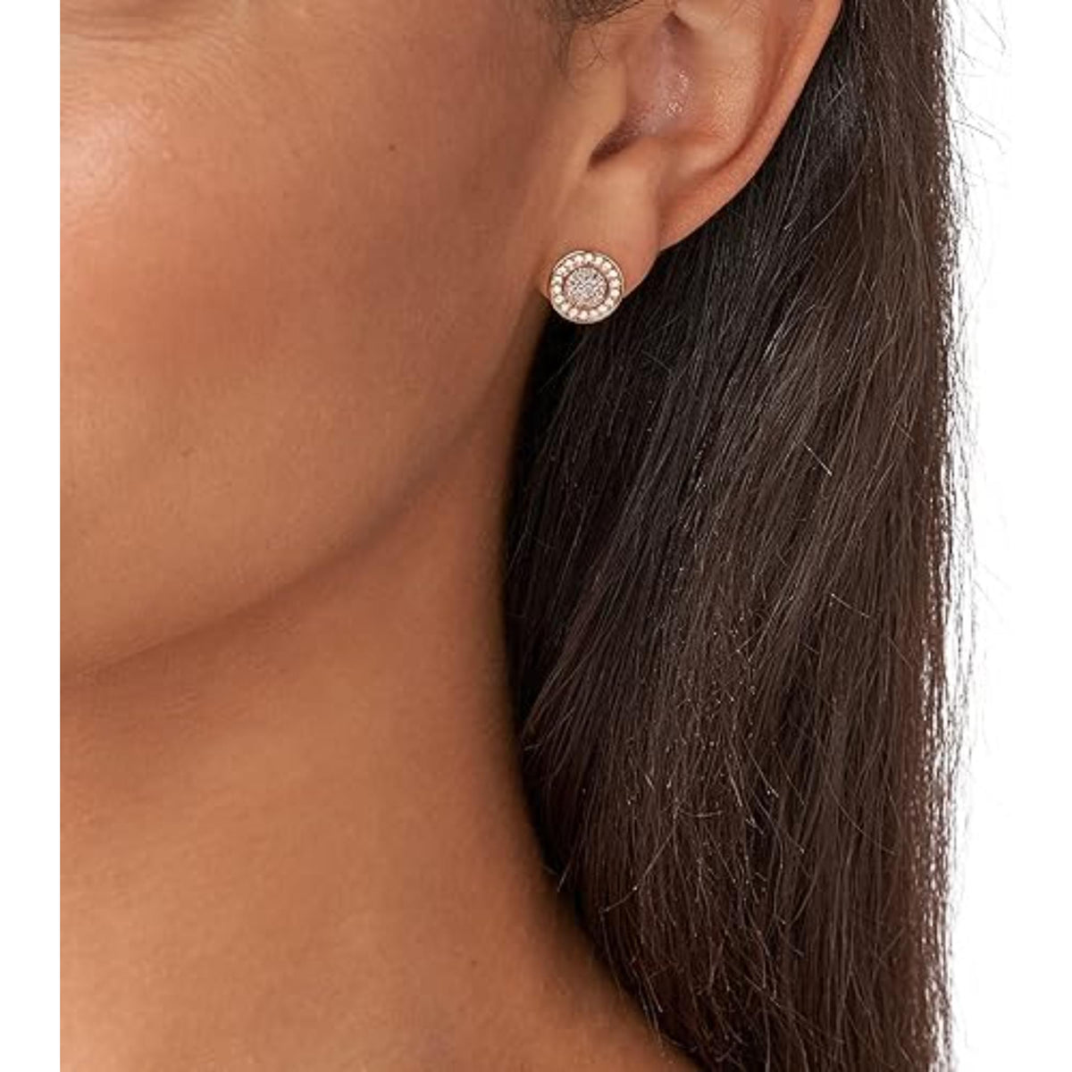 Round rose gold mother-of-pearl stud earrings on ear with crystal halo center.