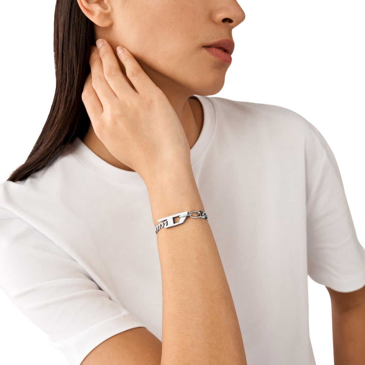 Stainless steel chain bracelet worn on woman's wrist with clasp centered