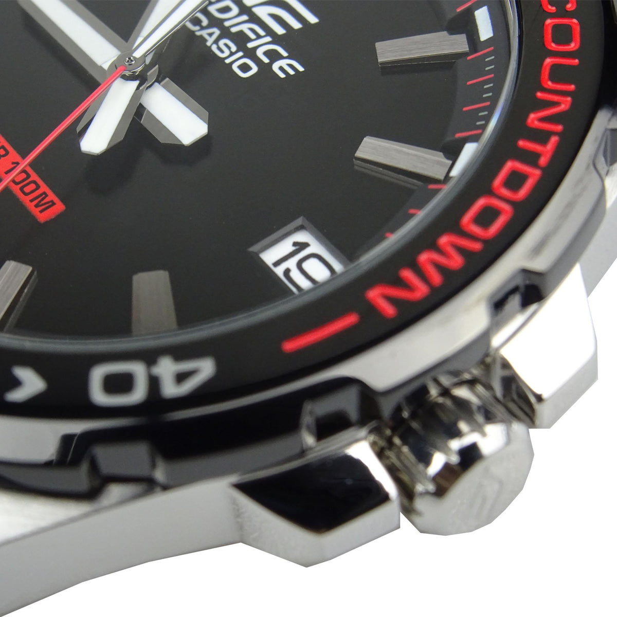Men's watch close-up: black Countdown bezel with red numerals and date window, leather strap