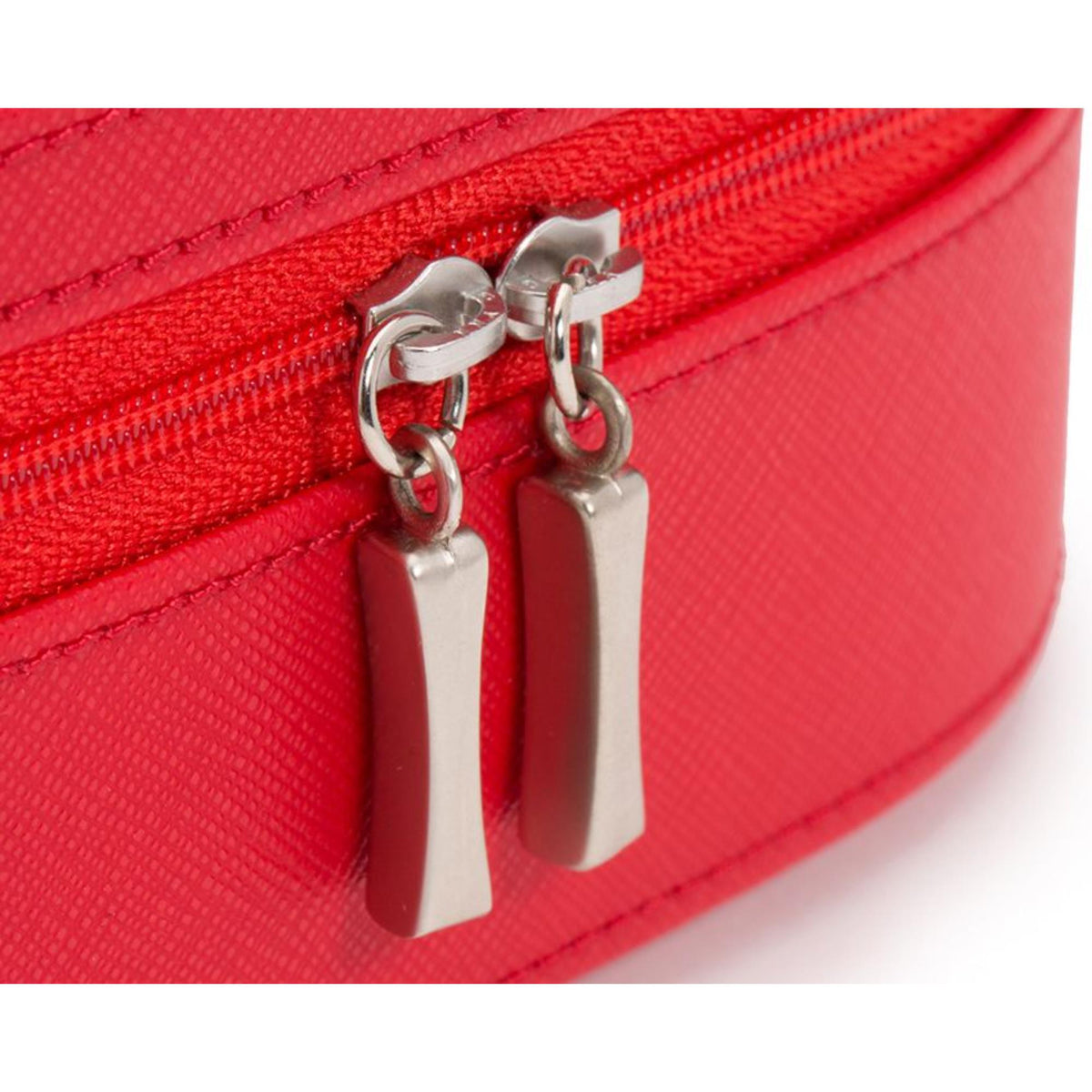 Close-up of red zip case zipper with two silver pull tabs and metal rings