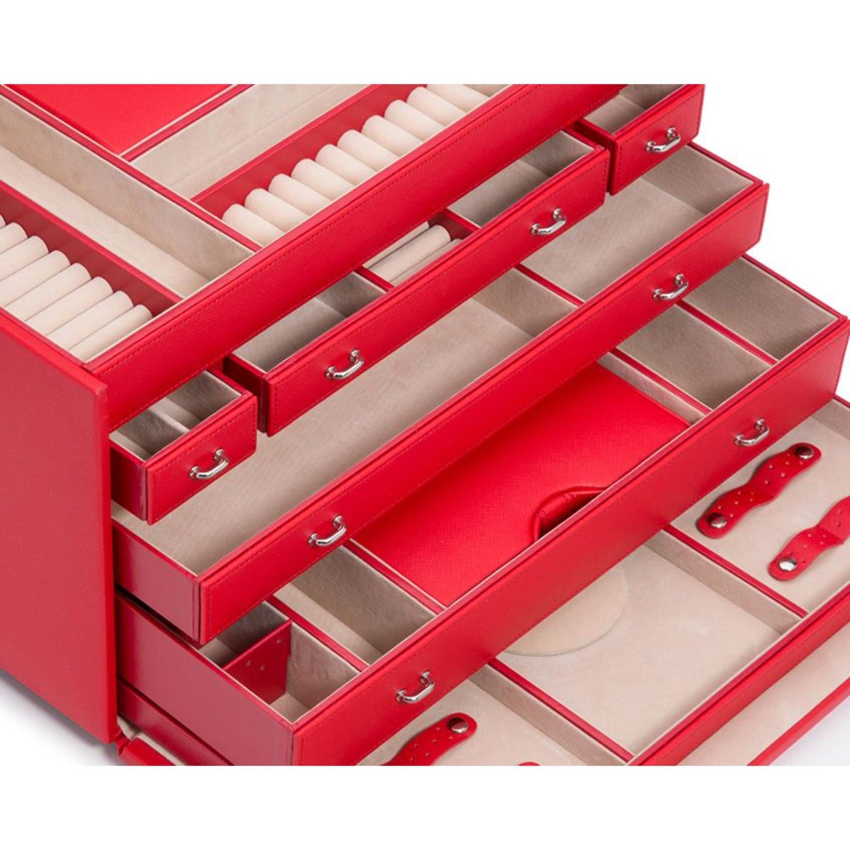 Interior of red jewelry armoire with padded compartments and drawer pull handles