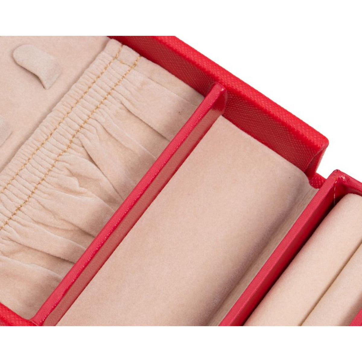 Close-up of open red jewelry box compartments with beige lining and dividers