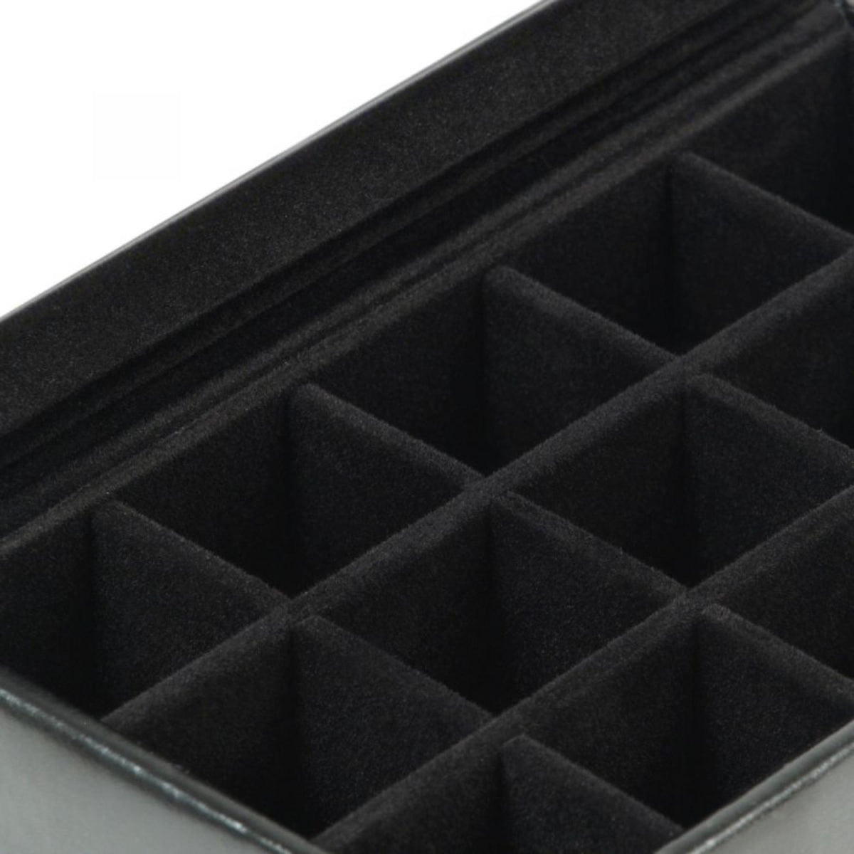 Close-up of black felt insert with grid of cufflink compartments