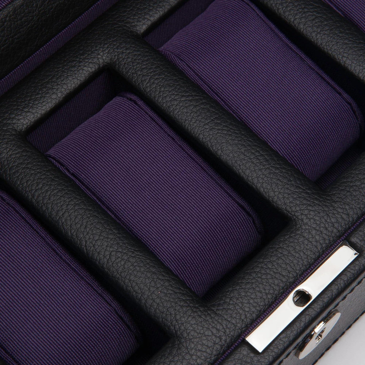Close-up of purple watch cushions inside a black leather-look watch box