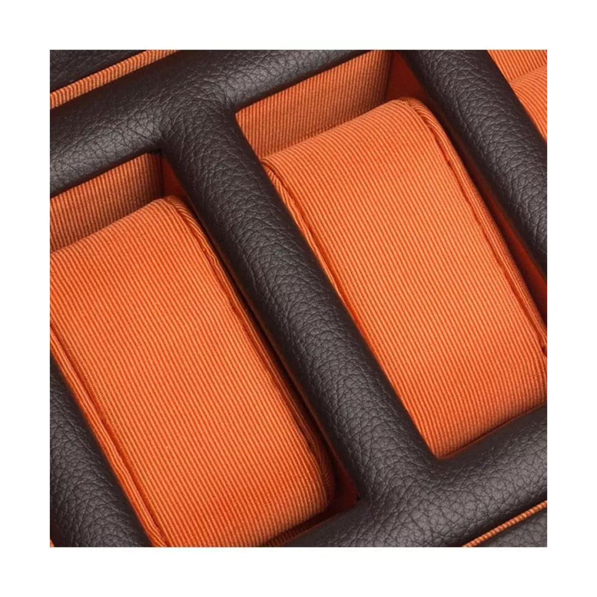 Orange watch holder cushions with black leather-look dividers inside the watch box.