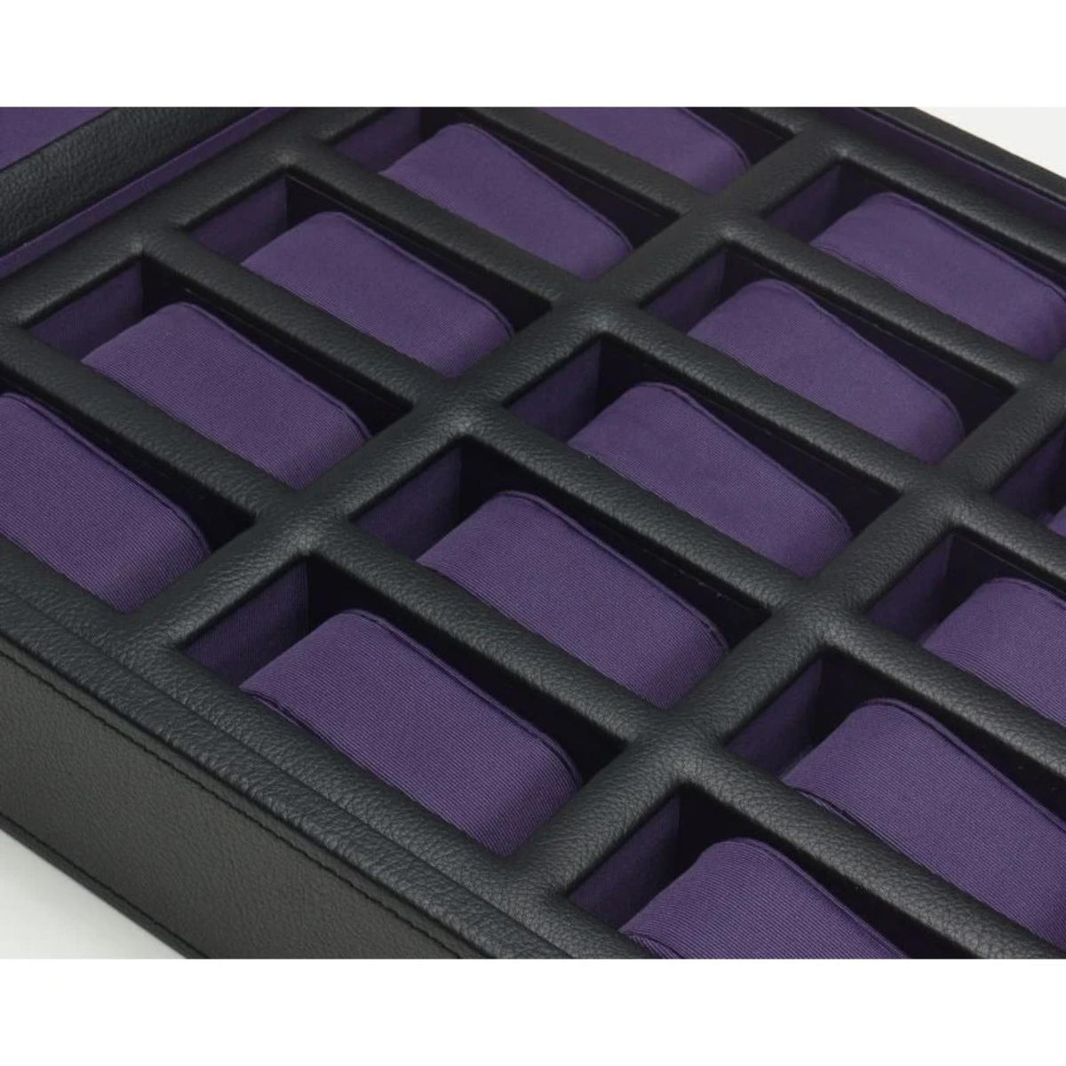 Close-up of purple watch compartments on black grid insert