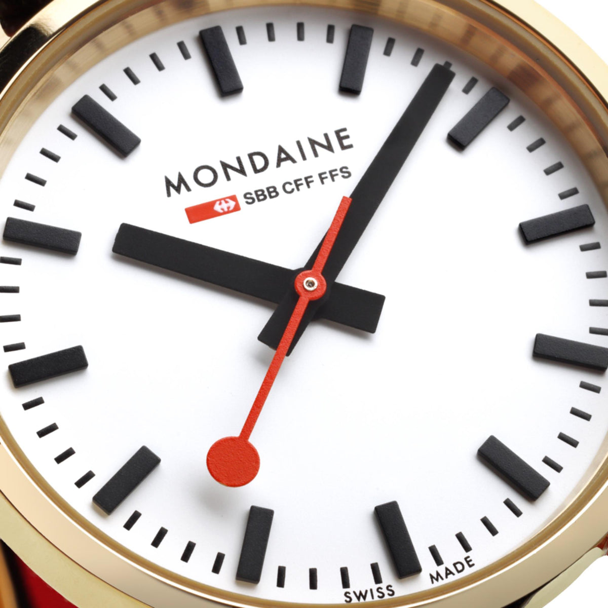 Close-up of Mondaine white watch dial with black markers and red second hand