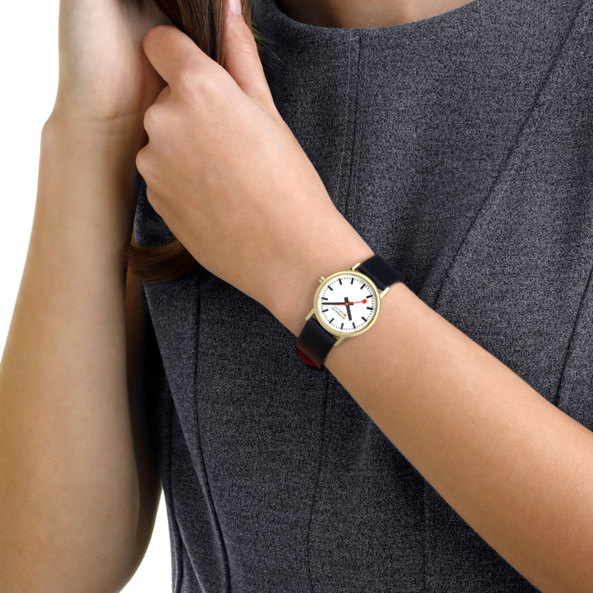 Mondaine women’s wristwatch with black leather strap and white dial with red second hand