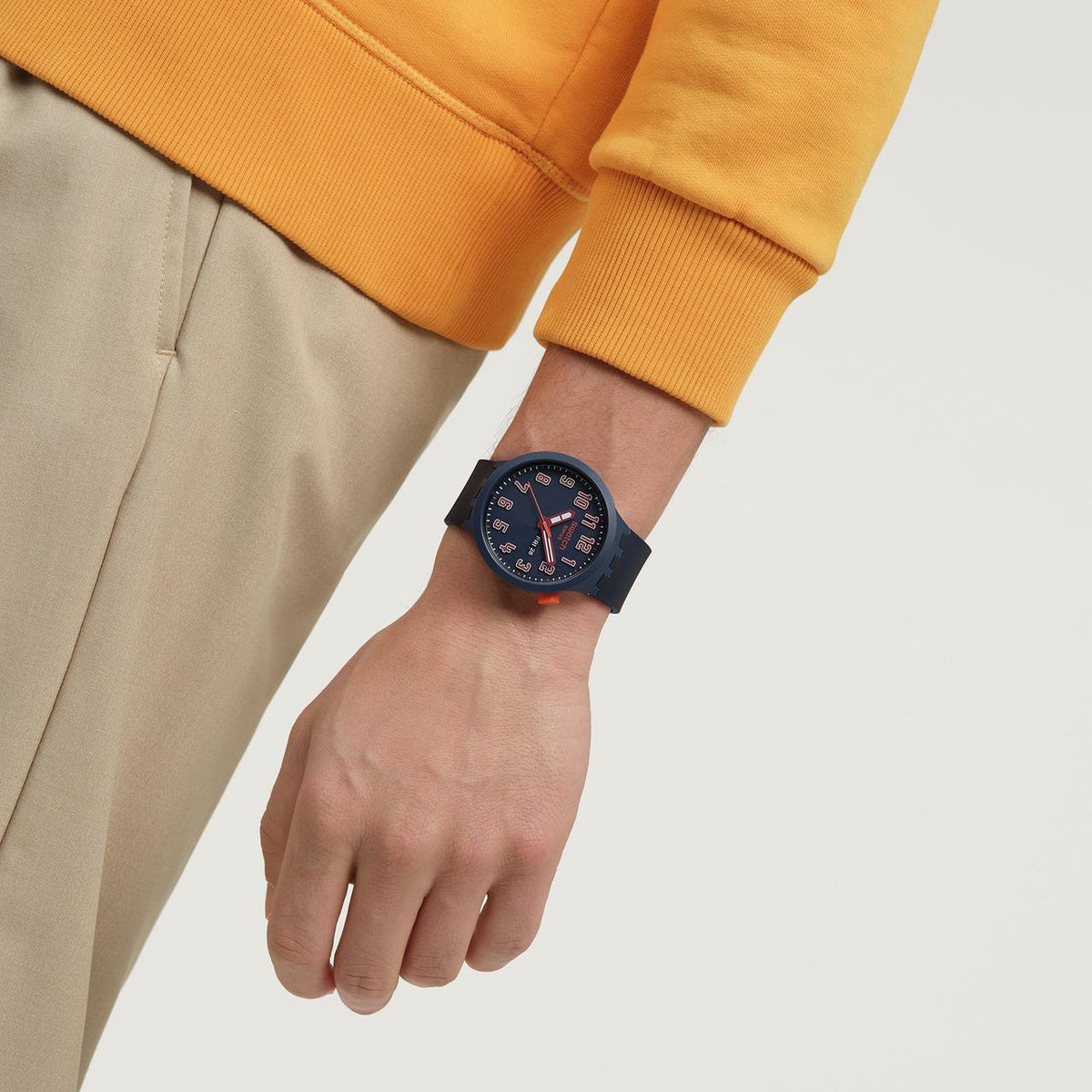Dark blue silicone strap watch with orange markers and three-hand dial