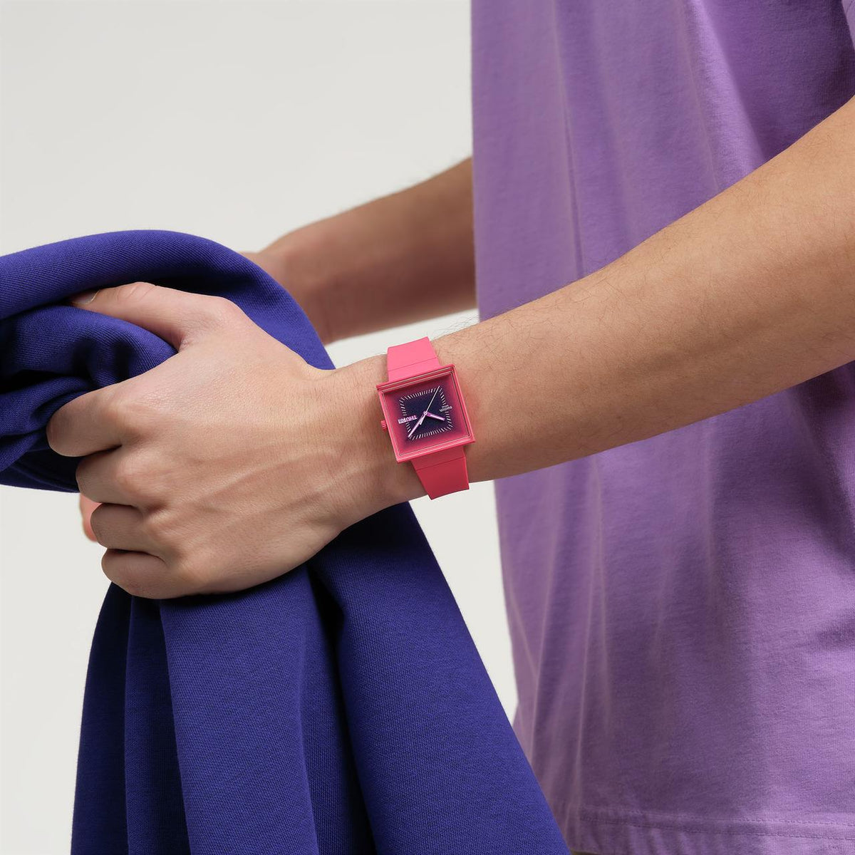 Berry pink square watch on wrist with pink silicone strap and glowing dial markers