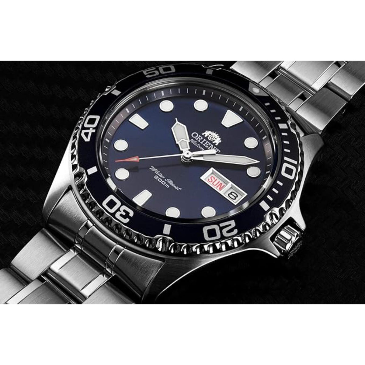 Orient diver watch with navy blue dial, date window, and black bezel