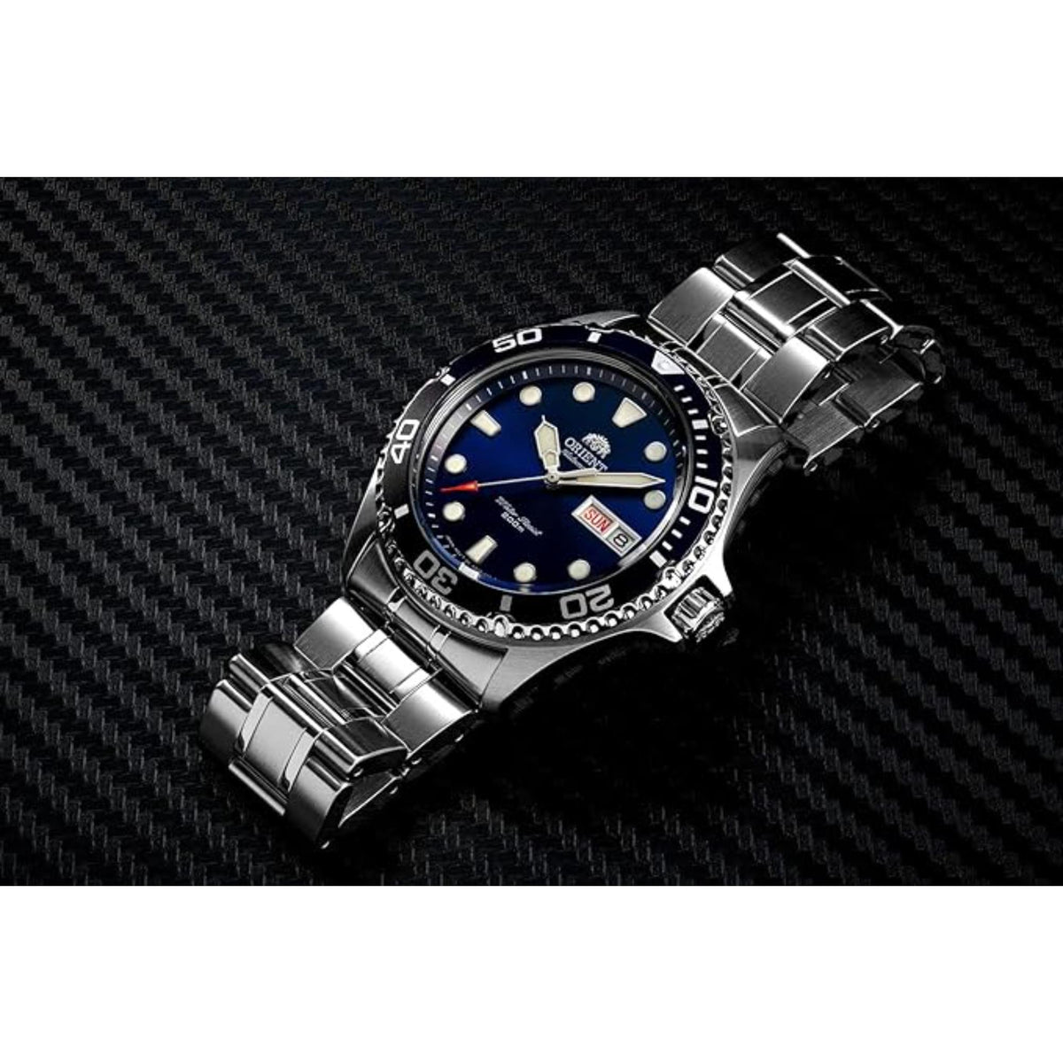 Steel diver watch with blue dial, black bezel, and three-link bracelet