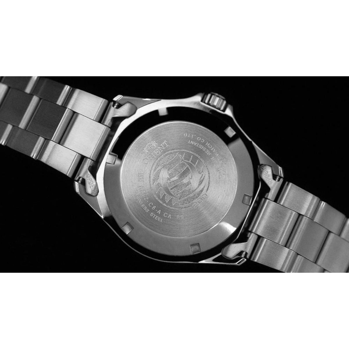 Stainless steel watch caseback with engraved emblem on metal bracelet